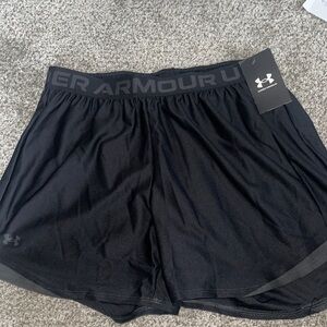 Woman’s under armour black shorts . Medium new in package